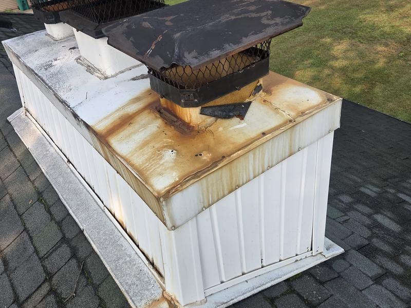 A badly rusted chase cover with standing rust and a lifted seam